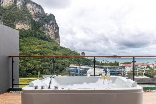 a bath tub with a view of a mountain at Panan Krabi Resort in Ao Nang Beach