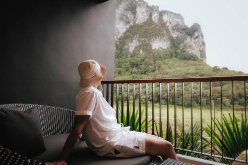 a person sitting on a couch looking out a window at Panan Krabi Resort in Ao Nang Beach