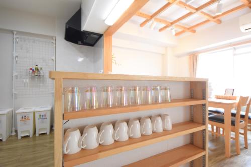 a room with a bunch of glass vases on shelves at Comfy Stay TDS in Nara