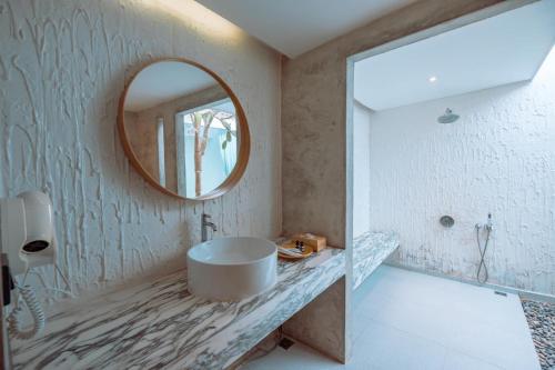 a bathroom with a round sink and a mirror at Myth Koh Larn resort bar and bistro in Ko Larn