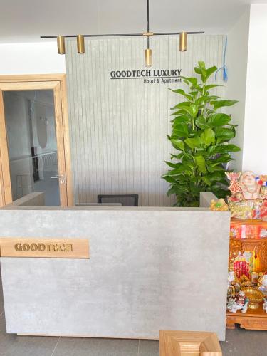 a reception desk with a sign for a good food library at GOODTECH LUXURY Hotel & Apartment in Da Nang