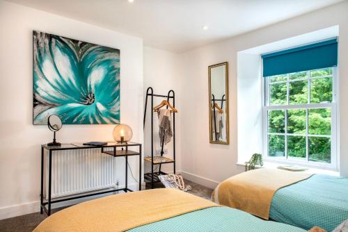 1 Schlafzimmer mit 2 Betten und einem Fenster in der Unterkunft Luxury Town House, Tavistock (sleeps 4) in Tavistock