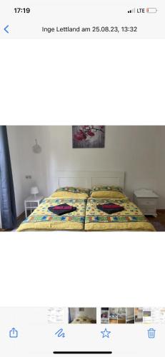 a bedroom with a bed with a yellow bedspread at Villa Reder in Bad Sauerbrunn