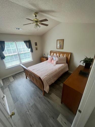 1 dormitorio con 1 cama y ventilador de techo en Lovely townhouse, en Charlotte