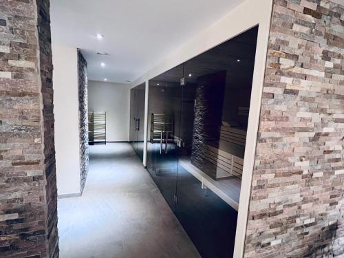 a hallway of a house with a brick wall at Hotel & Restaurant Goldener Pflug in Ludwigsburg