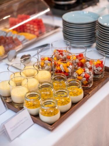 a buffet with eggs and other food on a table at De Syloia Hotel in Hanoi