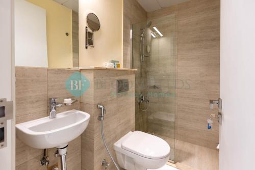 a bathroom with a toilet and a sink and a shower at Classic 2 Bedroom In Oasis in Al Qurayyah