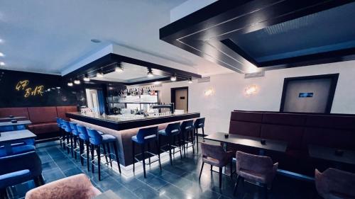 a restaurant with blue chairs and a bar at Hotel & Restaurant Goldener Pflug in Ludwigsburg