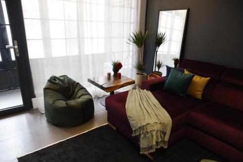 a living room with a couch and a table at Oldtown Prishtina Apartments in Pristina
