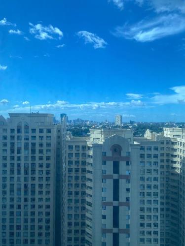 a view of a city with tall buildings at Elegant 2BR, 2 BA Suite Beside Eastwood Mall in Manila