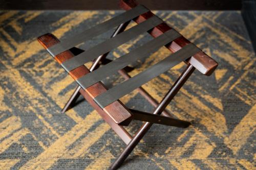 a wooden chair sitting on top of a carpet at HOTEL MYSTAYS Hamamatsucho in Tokyo