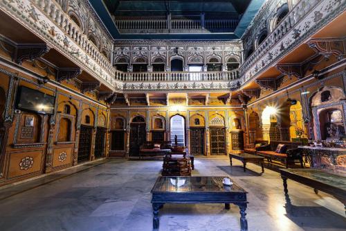 a large room with a table in the middle of it at Hotel Radhika Haveli, Mandawa in Mandāwa