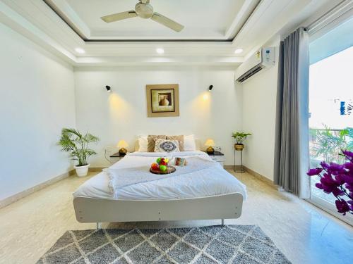 a bedroom with a bed with a bowl of fruit on it at Bedchambers Serviced Apartments, Ardee City in Gurgaon