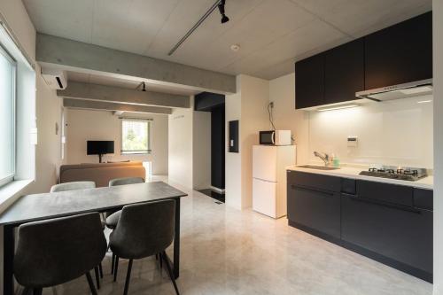 a kitchen with a table and chairs in a room at LUXE Minami Aoyama in Tokyo