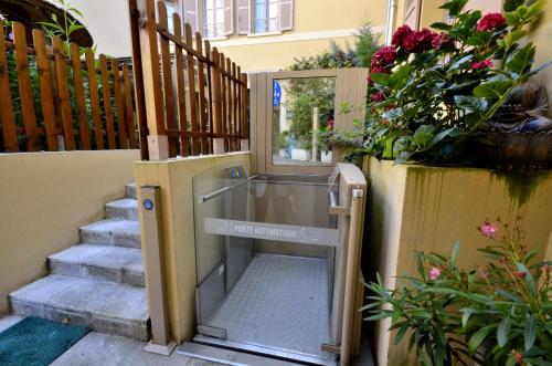 an open door on a stairway with flowers at Hôtel du Fort in Meulan