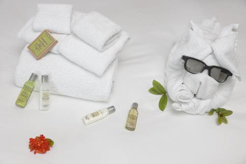a towel animal with sunglasses and some cosmetics on a table at Hilton Garden Inn Zhongshan Guzhen in Zhongshan