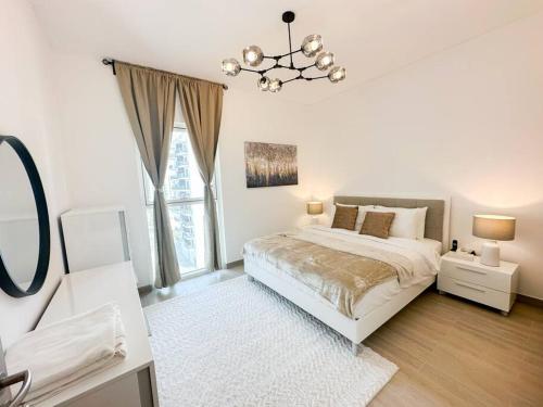 um quarto branco com uma cama e um lustre em Casa Dei Ricordi 620WB8 em Abu Dhabi
