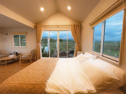 a bedroom with a large bed with a large window at Northland Pai in Pai