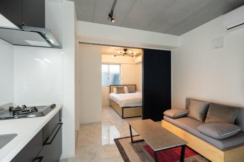 a kitchen and living room with a couch and a bed at LUXE Minami Aoyama in Tokyo