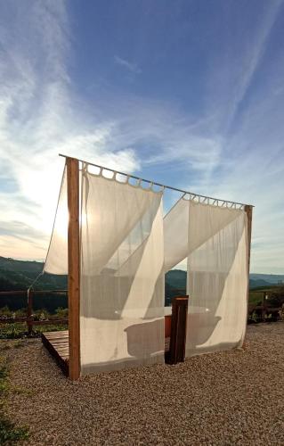 a wooden frame with a white curtain on a hill at B&B Mermaid n 16/a in Treiso