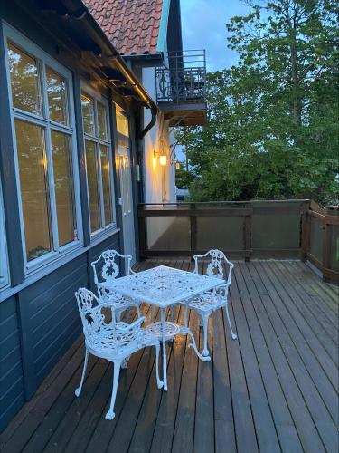 a table and two chairs on a deck at Hotell Stavstensgården in Trelleborg