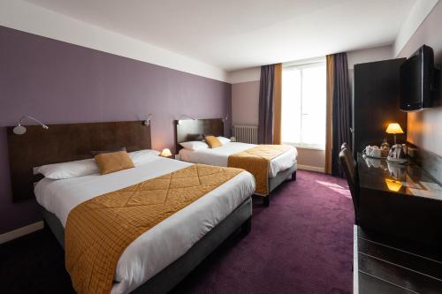 a hotel room with two beds and a flat screen tv at Best Western Adagio Saumur in Saumur