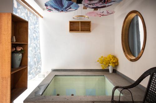 a house with a swimming pool in the middle of a room at Tingjian Musu Private Soup Design Homestay - South Gate of Wuzhen Xizha Scenic Area in Tongxiang