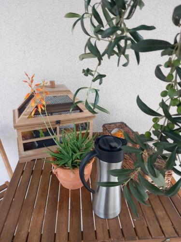 a table with plants and a coffee mug on it at Millésime in Perville