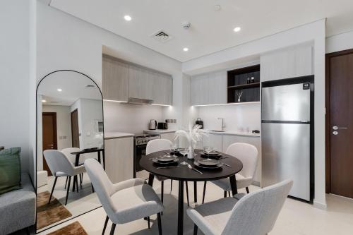 a kitchen and dining room with a table and chairs at Luxury apartments at Vida Residences in Dubai