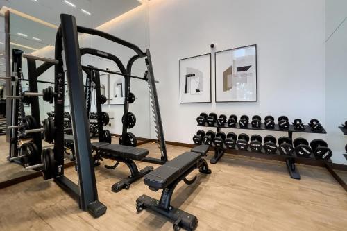 a gym with a row of tread machines at Luxury apartments at Vida Residences in Dubai