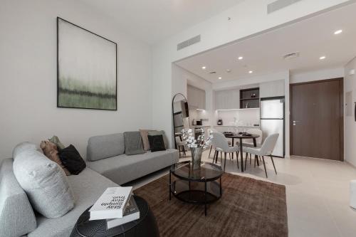 a living room with a couch and a table at Luxury apartments at Vida Residences in Dubai