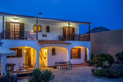 a large white house with a patio at night at Villa Diamanti in Monemvasia