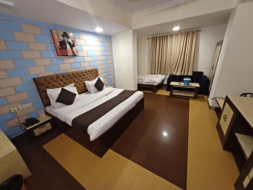a hotel room with a bed and a couch at Hotel V inn Sindhi Camp in Jaipur