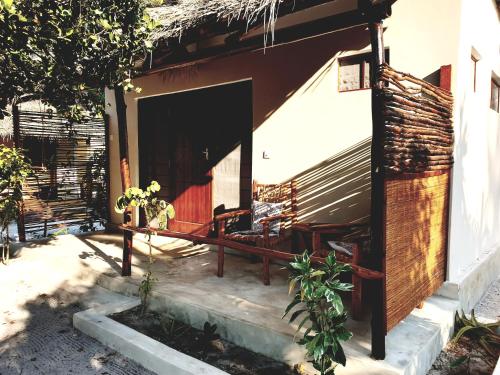 a small house with a porch and a patio at Michamvi Spirit Lodge in Michamvi