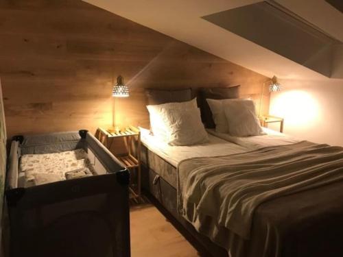 a bedroom with a large bed in a attic at Qwadrat Apartament 15 in Bielsko-Biala city center in Bielsko-Biala