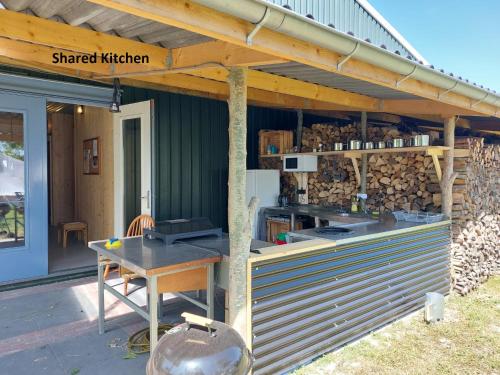 a wood shop with a table and a counter at Kampeerplaats Glamping Essenhof in Aagtekerke