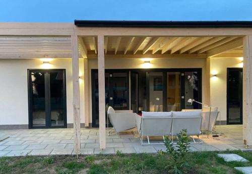 a patio with a table and chairs on a house at Art House - Révfülöp in Révfülöp