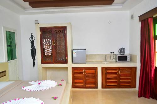 a kitchen with a sink and a counter top at Kahawa Sunset View Zanzibar in Zanzibar City