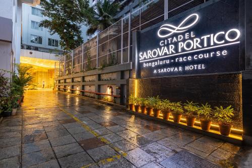 a building with a sign on the side of it at Citadel Sarovar Portico Bengaluru in Bengaluru