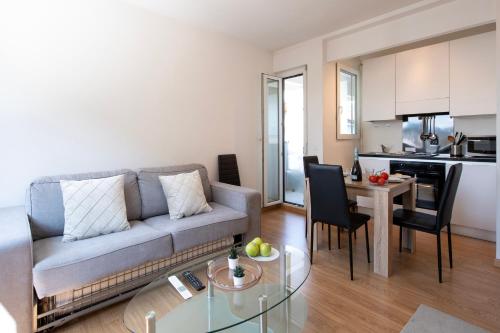 a living room with a couch and a table at Lean Home - Happy Rentals in Lugano