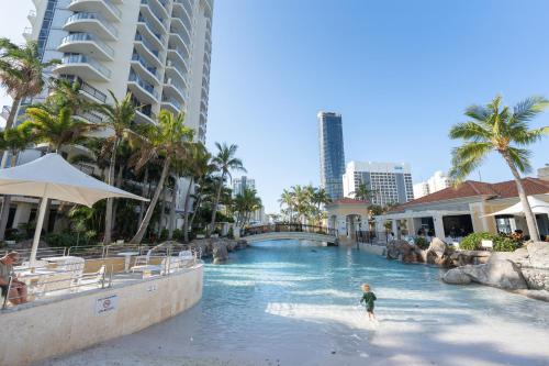 a child in the water at a pool at a resort at Chevron Renaissance - Resort Style Living by Gold Coast Premium in Gold Coast