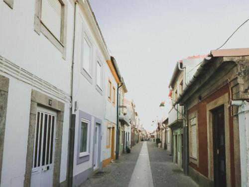 an empty street in a city with buildings at CASA DA RIBEIRA in Viana do Castelo