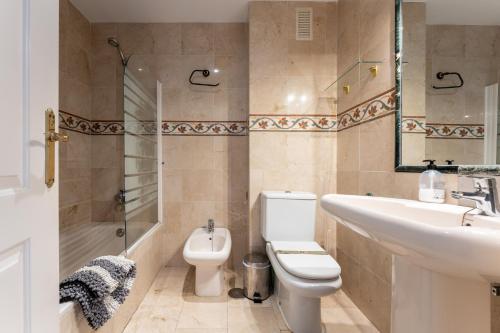 a bathroom with a sink and a toilet and a shower at 224 Seaview La Cala de Mijas in La Cala de Mijas