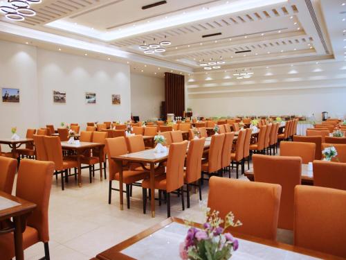 a large room with tables and chairs in it at ROZANA HOTEL in Muscat