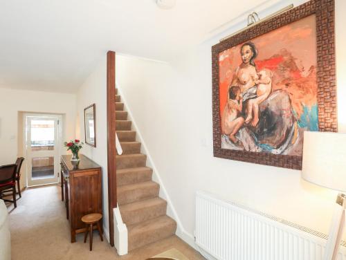 a staircase in a home with a painting on the wall at Ty Nain in Caernarfon