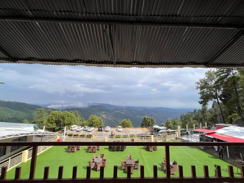 a view from a window of a field of grass at BULAND HEIGHTS in Murree