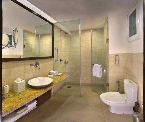 a bathroom with a toilet and a sink and a shower at Four Points by Sheraton New Delhi, Airport Highway in New Delhi