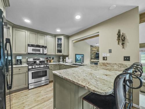 a kitchen with stainless steel appliances and a granite counter top at Woods25 Townhome Condo in Copper Mountain