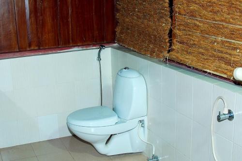 a bathroom with a white toilet in a stall at Elephant Courtyard- A Heritage Homestay in Alleppey