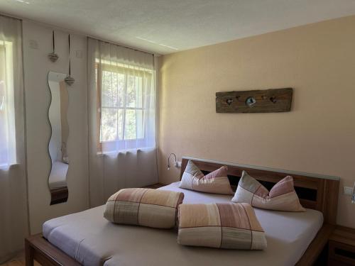 a bedroom with a bed with two pillows on it at Feichterhof in Riva di Tures